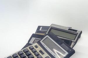 A pile of old calculators symbolizes inflation, representing outdated financial tools and the increasing cost of living photo