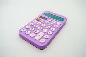 A vibrant purple calculator with pink buttons on a white background. The calculator displays numbers on its screen and features basic arithmetic functions, making it ideal for everyday calculations photo