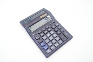 A black electronic calculator with a large display and multiple function buttons on a white background. Ideal for office, school, or home use photo