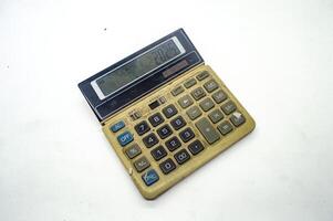 Old, vintage calculator with a worn out keypad and display showing 2025. Ideal for retro technology or nostalgia themed concepts photo