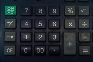 Close up of a calculator keypad with various function keys, including numbers, arithmetic operations, and special functions. Ideal for finance, education, and office related concepts. photo