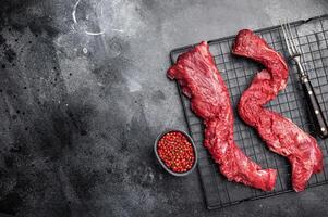 Raw Beef Steak Machete, uncooked meat . black background. top view photo