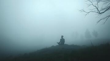 Serene Silhouette. Meditative Figure in Misty Landscape photo