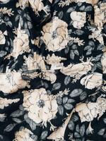 A series of abstract multi-colored rose flower patterns in medium color, rose material fabric solid black background photo