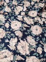 A series of abstract multi-colored rose flower patterns in medium color, rose material fabric solid blue background photo