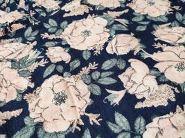 A series of abstract multi-colored rose flower patterns in medium color, rose material fabric solid blue background photo
