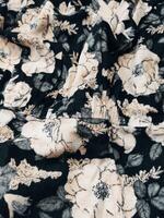 A series of abstract multi-colored rose flower patterns in medium color, rose material fabric solid black background photo