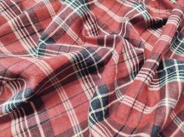 The pattern and background of the fabric has a red checkered motif photo