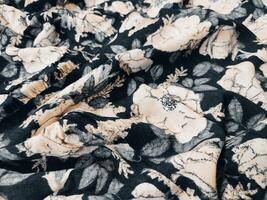 A series of abstract multi-colored rose flower patterns in medium color, rose material fabric solid black background photo