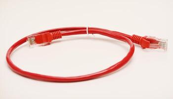 Red internet cable on a white background. The RJ-45 connector. photo