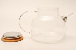 Glass teapot with wooden lid on a white background. photo