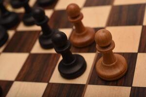 Black and white chess. Wooden chess on a board. A chess game. photo