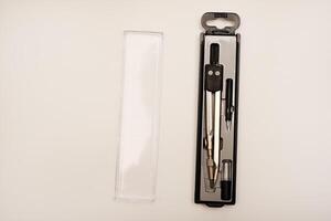 Black compasses on a white background. A drawing tool. photo