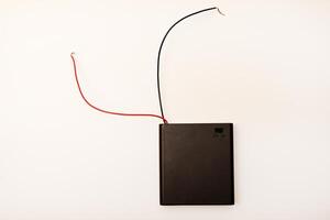 Portable battery pack with wires on a white background. photo
