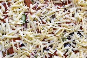 Cooking meat pizza. Pizza toppings before frying. photo