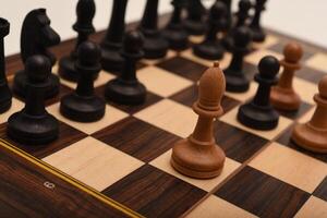 Black and white chess. Wooden chess on a board. A chess game. photo