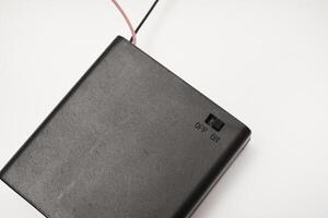 Portable battery pack with wires on a white background. photo