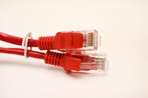 Red internet cable on a white background. The RJ-45 connector. photo