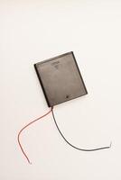 Portable battery pack with wires on a white background. photo