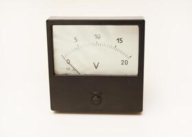 Measuring device. An old voltmeter. Arrow voltage meter. photo