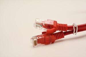 Red internet cable on a white background. The RJ-45 connector. photo