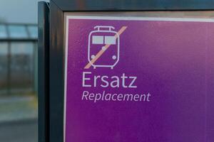 Train replacement announcement sign indicating service interruption at a transportation station for passengers traveling in the area photo