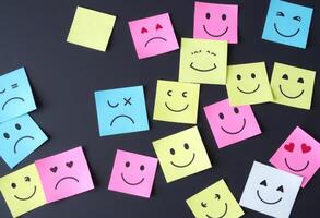 Many colorful post it notes with smiley faces photo