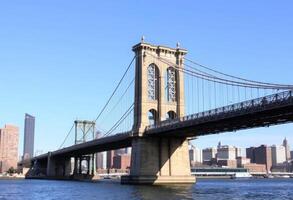The brooklyn bridge spans across the water in new york photo
