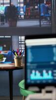 Vertical Modern office space with financial data on a monitor used for meetings, running detailed analytics and graphs. Empty workspace to develop business strategies for success, productivity tools. video
