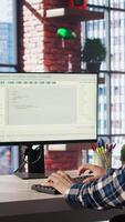Programmer at desk typing code into computer, developing software programs, consulting green screen tablet. Man in home office fixing errors in application using chroma key device and PC, camera A video