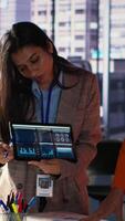 Vertical Multiethnic women executives uniting forces in a collaborative meeting, focused on data management and business development. Experts with leadership skills fighting for empowerment. Camera A. video