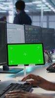 Vertical System administrator using isolated screen tablet, working in server farm to optimize it for data processing requirements. Software developer coding on chroma key device in data center, camera A video