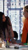 Vertical General director reviewing data analytics with her team for successful development plan, working to expand the enterprise globally. Female CEO showing great leadership skills in a meeting. Camera A. video