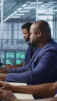 Vertical Happy data center employee pleased after successfully installing cybersecurity framework, seeing confirmation after reducing security incidents and enhancing data protection protocols, camera A video