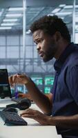 Vertical Engineer in data center implementing advanced AI driven predictive maintenance systems to proactively identify and resolve potential hardware failures before they impact operations, camera A video