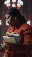 Vertical Female educator preparing her teaching materials and resources in the library, leveraging her expertise to mentor scholars and create a productive academic atmosphere for young minds. Camera A. video