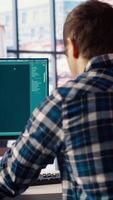 Man solving personal tasks with AI LLM chatbot answering prompts using predictive technology. Person using computer in apartment to interact with large language model program, camera B video