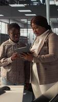 Vertical Business associates reviewing objectives data and performance metrics in a modern office, focusing on corporate strategy and decision making for sustainable enterprise development. Camera B. video