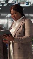 Vertical African American team collaborates on a financial planning project in a corporate office, emphasizing teamwork and data analysis to make informed decisions for future firm growth. Camera B. video