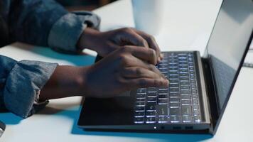 Teleworker working from home, typing on laptop keyboard, writing in document. Remote employee pressing keys on notebook keyboard, sending emails to business partners, camera A close up video