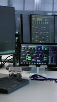 Vertical PCs, headphones and tablets in data center employing machine learning technology to maintain company network infrastructure. Electronic devices used in server room to ensure optimal system performance video