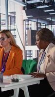 Vertical Multicultural group of women in a high powered office meeting, promoting gender equality and female authority in a work environment. Leaders in a men dominated business industry. Camera B. video