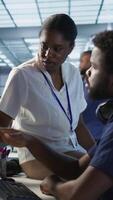 Vertical Manager taking feedback from data center engineer maintaining company network infrastructure. Team leader in server hub listening worker ensuring optimal system performance, camera A video
