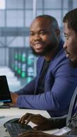 Vertical Cheerful coworkers in data center implementing AI predictive maintenance systems. Server room engineers using artificial intelligence to identify hardware failures impacting operations, camera A video