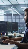 Vertical Woman assisting data center programmer in solving tasks, maintaining company network infrastructure. Supervisor in server room helping employee ensuring optimal system performance video