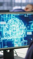 Vertical Machine learning expert in AI server room developing disaster recovery plans ensuring minimal downtime. Employee monitoring performance in artificial intelligence ran data center, camera A video