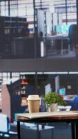Vertical Luxurious office space in a multinational company with a monitor, presenting performance metrics and data analysis on a TV screen. Modern workspace in a corporation used for meetings. video