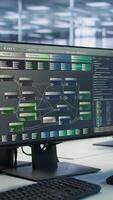 Vertical Close up of computer displays in empty data center establishment monitoring hardware energy consumption. PC screens on server hub office desk showing programming software video
