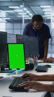 Vertical Admin using isolated screen tablet, working in server farm to optimize it for data processing requirements. IT specialist coding on mockup device in data center, camera A video