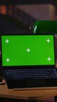 Vertical Focused schoolgirl engaged in academic tasks with green screen at a library, working on school assignments with her laptop. Solving class work tasks, searches information on internet. Camera B. video